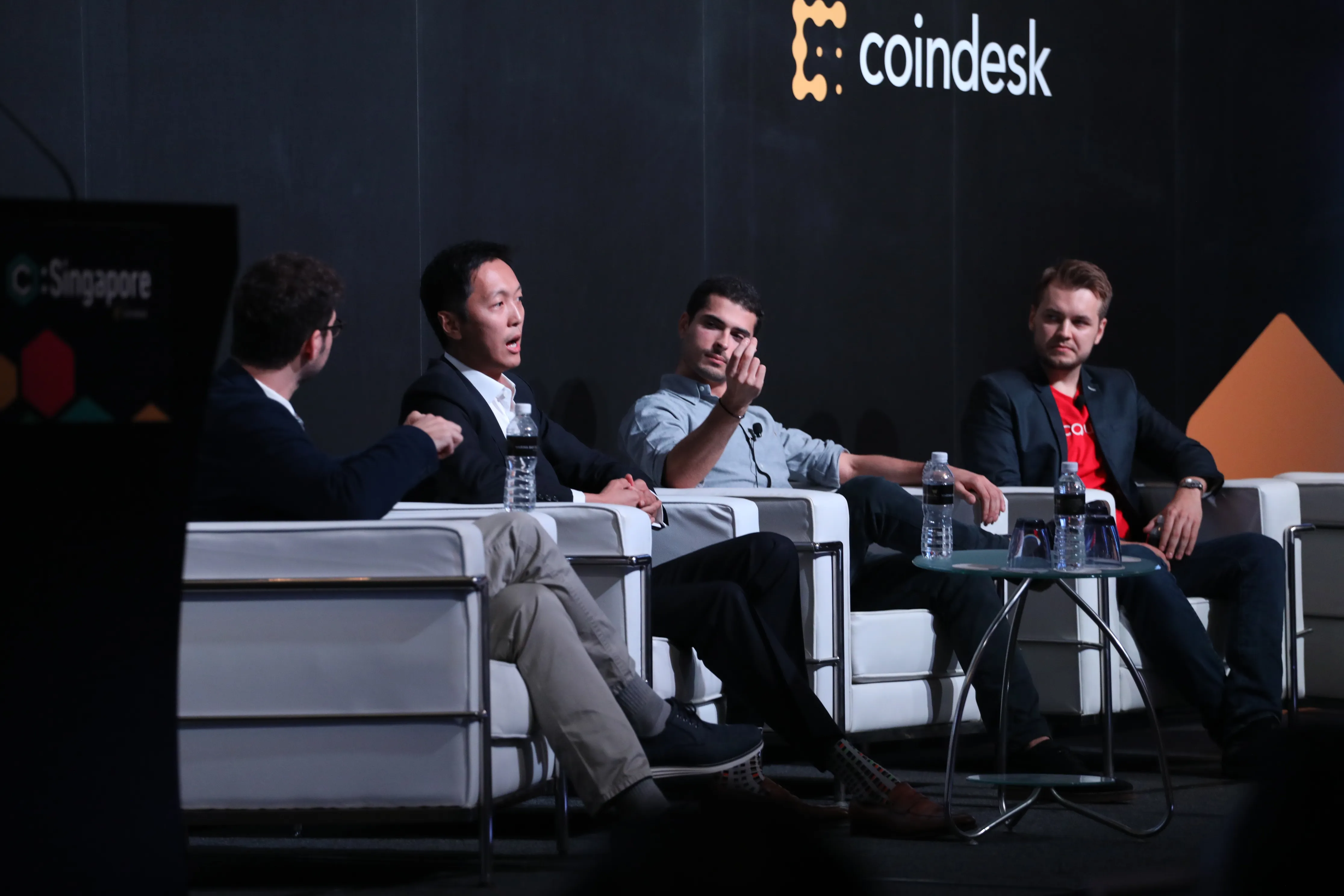Singapore coindesk conference with people talking on the stage